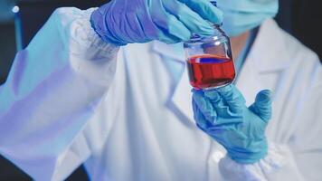 Young scientists conducting research investigations in a medical laboratory, a researcher in the foreground is using a microscope video