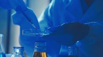 Young scientists conducting research investigations in a medical laboratory, a researcher in the foreground is using a microscope video