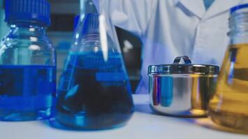 Young scientists conducting research investigations in a medical laboratory, a researcher in the foreground is using a microscope video