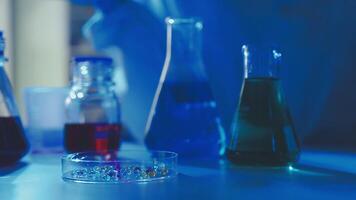 Young scientists conducting research investigations in a medical laboratory, a researcher in the foreground is using a microscope video