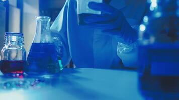 Young scientists conducting research investigations in a medical laboratory, a researcher in the foreground is using a microscope video