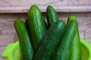 Fresh cucumbers in Kitchen basket. photo