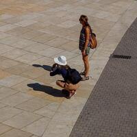 Bilbao, Vizcaya, Spain, 2024 - tourist taking photos on the street