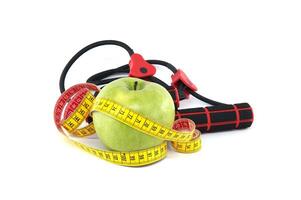 Apple and measuring tape in front of resistance band photo