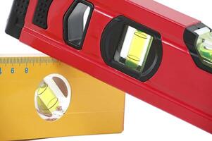 Red and yellow spirit level isolated on white background photo