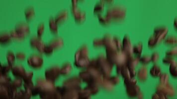 Coffee with green background, slow motion of coffee beans on green background video