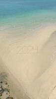 2024 written on sand. Concepts of entering the year 2024, beach getaway in 2024 video