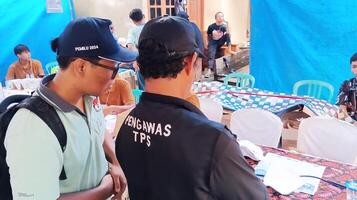 Demak, Indonesia - February, 2024 - Vote counting process at TPS, Indonesian presidential election. photo