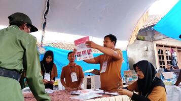 Demak, Indonesia - February, 2024 - Vote counting process at TPS, Indonesian presidential election. photo