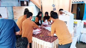 Demak, Indonesia - February, 2024 - Vote counting process at TPS, Indonesian presidential election. photo