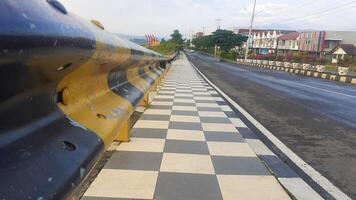 sidewalks on the edge of the road with iron guards photo