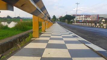 sidewalks on the edge of the road with iron guards photo