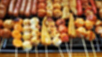 grilled sausages, skewered and grilled snacks blur the background photo