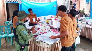 Demak, Indonesia - February, 2024 - Vote counting process at TPS, Indonesian presidential election. photo