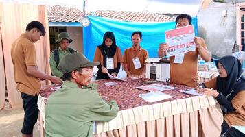 Demak, Indonesia - February, 2024 - Vote counting process at TPS, Indonesian presidential election. photo