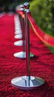 AI generated Macro view of red carpet with red rope barrier in a row. photo