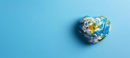 AI generated Heart shaped earth globe on blue background for environmental care with copy space photo