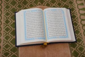 Holy Quran on a prayer mat. Ramadan Kareem. photo