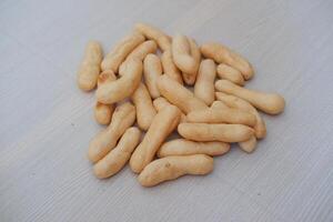 Close up of crunchy bread stick on wooden table background, stock photo