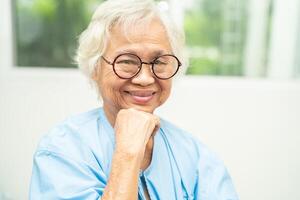 Asian senior woman wearing eyeglasses or vision glasses at home care service. photo