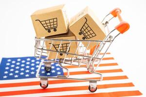 Box with shopping online cart logo and USA America flag, Import Export Shopping online or commerce finance delivery service store product shipping, trade, supplier. photo