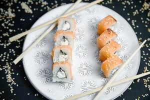 White Plate With Sushi and Chopsticks photo