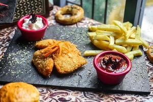 Tray of Food With Fried Chicken, Fries, and Dips photo