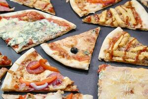 Assorted Types of Pizza on a Table photo