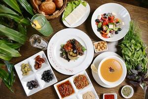 Wooden Table With Assorted Plates of Food photo