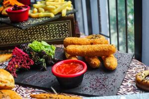 Table With Assorted Fried Food and Dipping Sauce photo