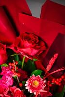 Colorful Flower Bouquet in Red Vase on a Table photo