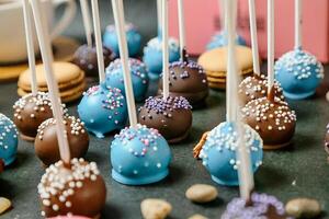 Assorted Chocolate Covered Cake Pops Arranged on a Table photo