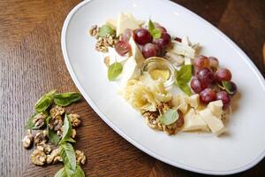 White Plate With Grapes and Cheese photo