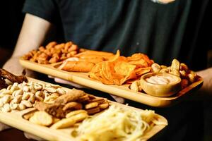 Man Holding Two Trays of Food at Outdoor Market photo