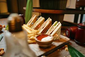 Plateful of Sandwiches and French Fries on Table photo