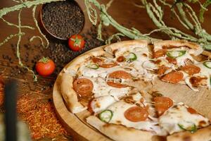 Pizza on Wooden Cutting Board photo