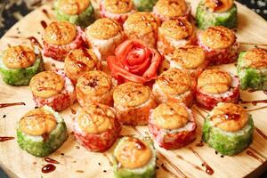 Assorted Sushi Varieties Arranged on Wooden Plate photo