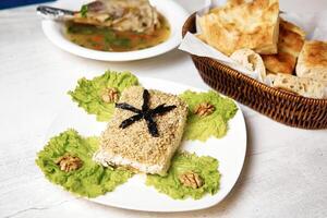White Plate With Food Next to Basket of Bread photo