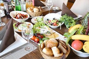 Wooden Table With Assorted Bowls of Food photo