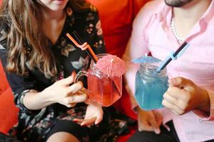 Couple Relaxing on Couch With Drinks photo