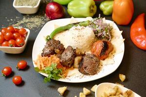 Plate of Meat and Vegetables on Table photo