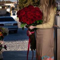 Woman Holding Bouquet of Red Roses photo