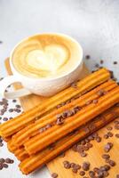 Cup of Cappuccino With Chocolate Chips on a Cutting Board photo