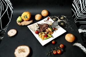 Black Table With White Plate of Food photo