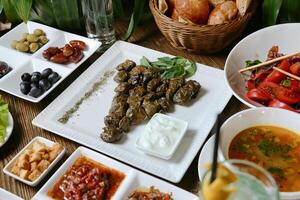 Table With Assorted Food Plates and Soup Bowls photo