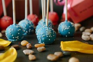Table With Blue Frosting Covered Cake Pops photo