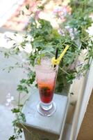 Tall Glass With Yellow Straw on Ledge photo