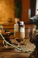 Glass of Liquid on Wooden Table photo
