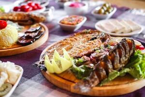 Table With Assorted Meat Dishes photo