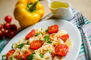 Farfalle pasta with cherry tomatoes photo